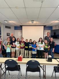 Girl Scout Troop 21437 presenting cookies to Luling VFD pictured with Chief Minnich and President Bourque.